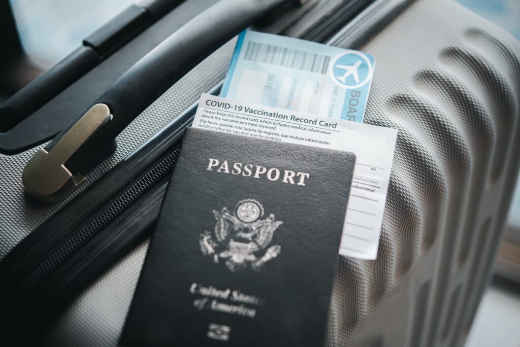 Passports and suitcases to prepare for the trip and coronavirus vaccination card